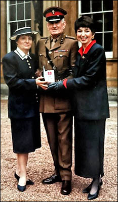 Photo of Rita, Roy and Gaynor Blewitt collecting Roy's MBE in 1993