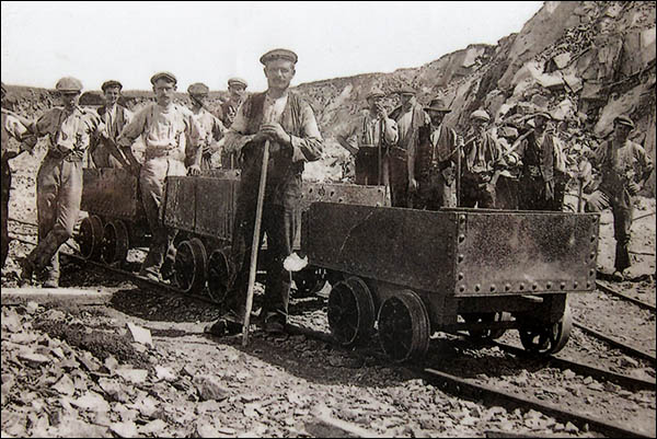 Old photo of quarrymen and trams at Porthgain